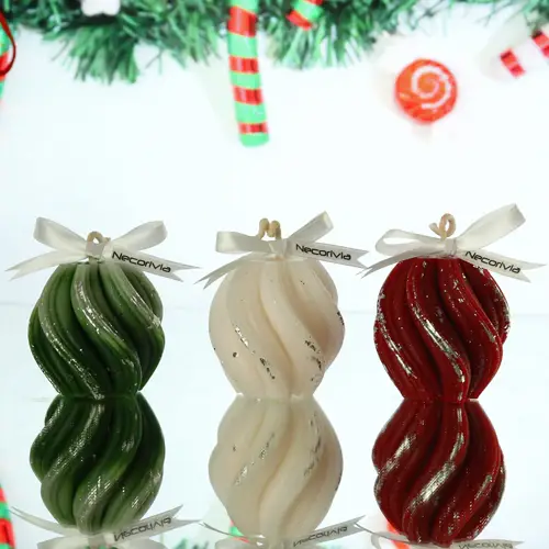 Christmas-themed swirl-shaped candles in green, white, and red with silver accents and ribbon bows.