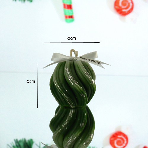 Green swirl-shaped candle with silver accents and a white ribbon bow.