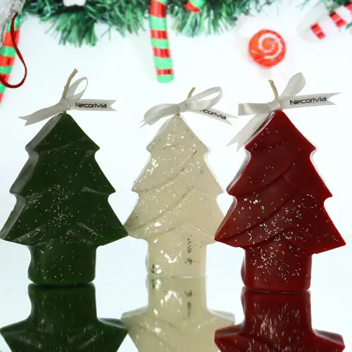 Christmas tree-shaped candles in green, white, and red with silver accents and ribbon bows.