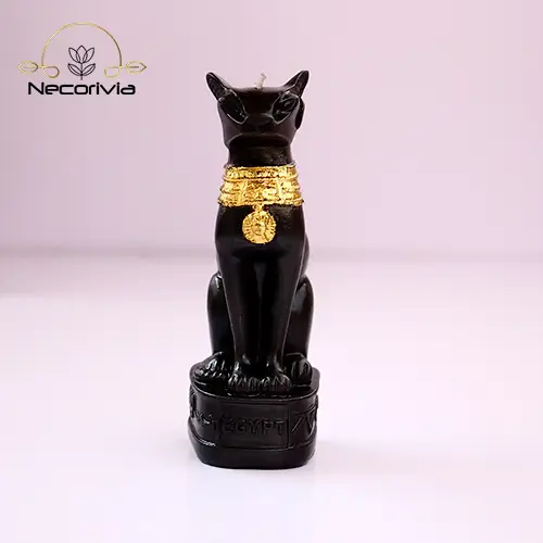 Black Bastet candle with gold accents on a pedestal