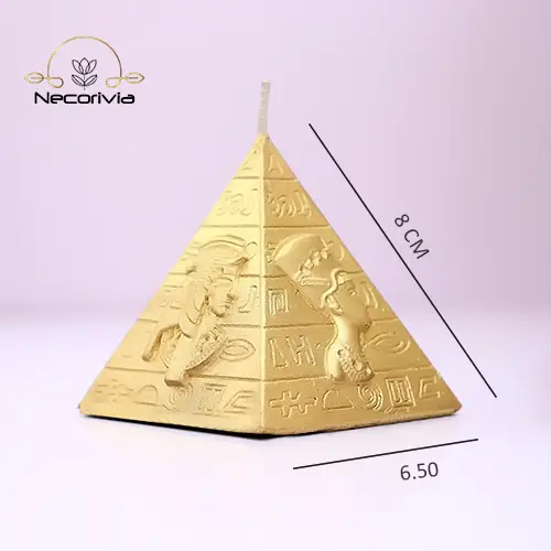 Gold pyramid-shaped candle with ancient Egyptian hieroglyphic designs.