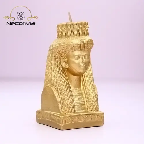 Gold candle bust of Meritamen, featuring detailed Egyptian design elements.