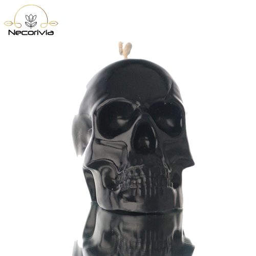 Black skull-shaped candle with a single wick.