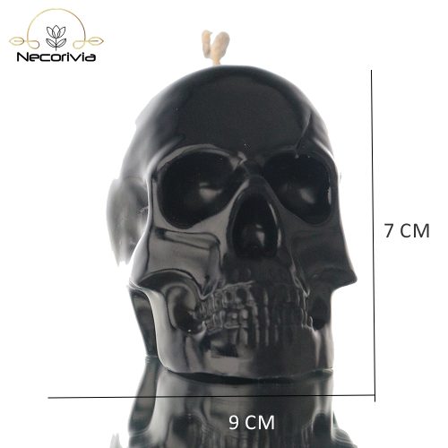 Black skull-shaped candle with a single wick.